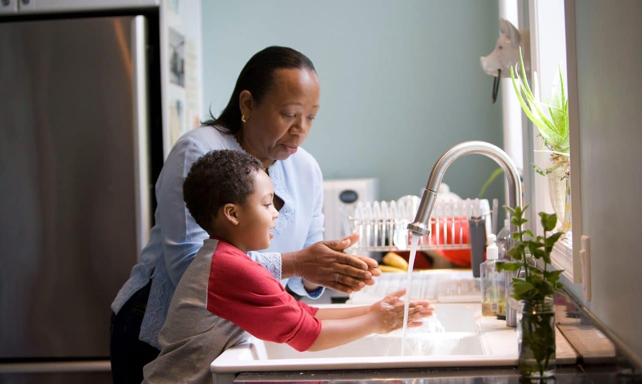mom and son washing hands to get rid of coronavirus