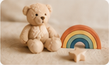Teddy bear beside a rainbow toy
